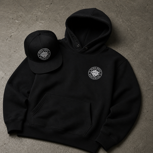 Black hoodie and cap with a logo on a gray surface